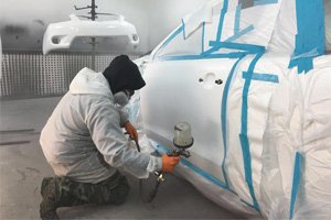 Auto body painter at work